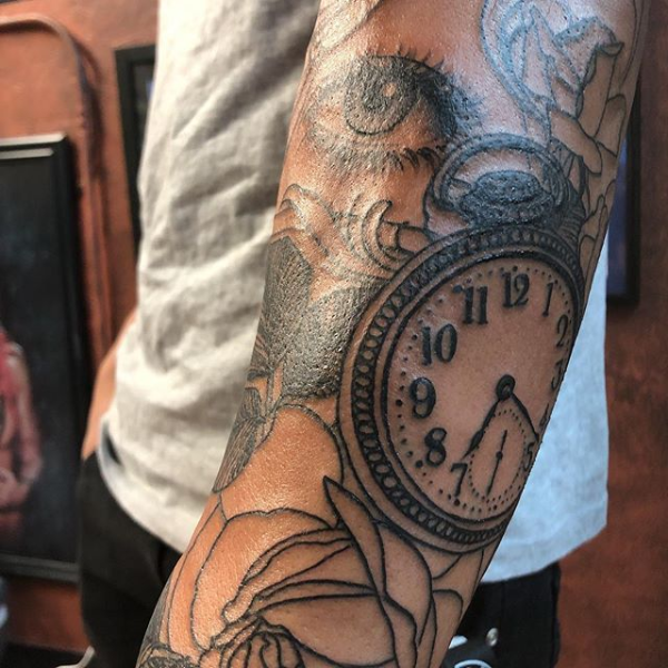 A clock tattoo on the arm