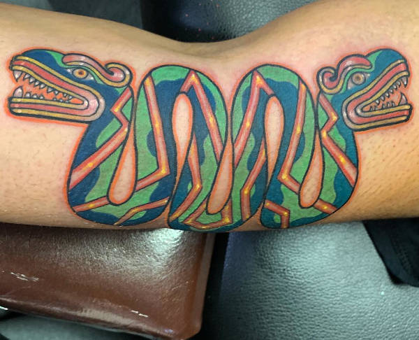 An aztec snake quetzalcoatl arm tattoo