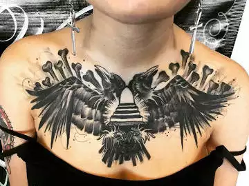 A twin raven tattoo on the arm