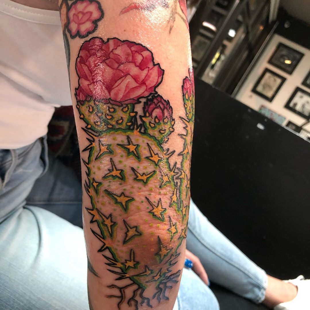 Cactus tattoo on the left inner forearm.